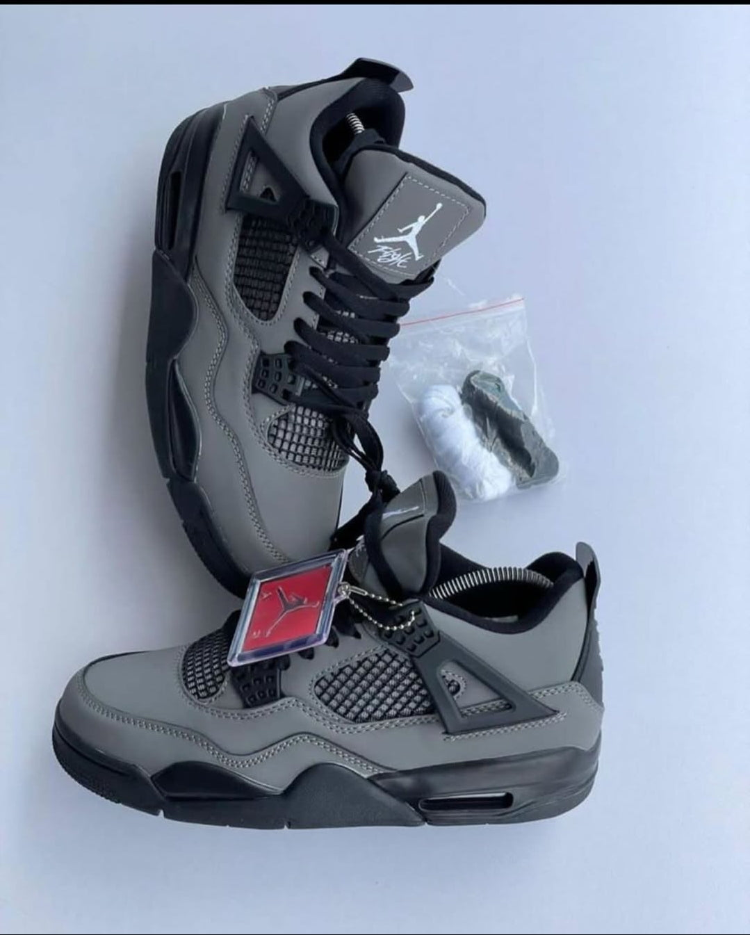 Nike Air Jordan 4 Retro sneakers in grey and black.